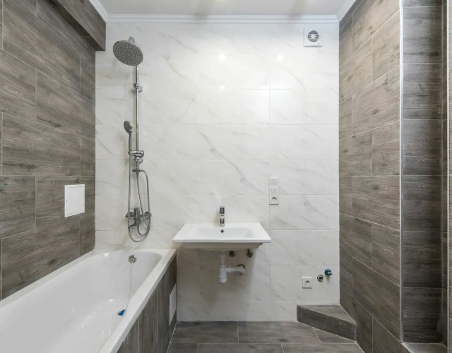 Finished bathroom plumbing with shower and sink fixtures