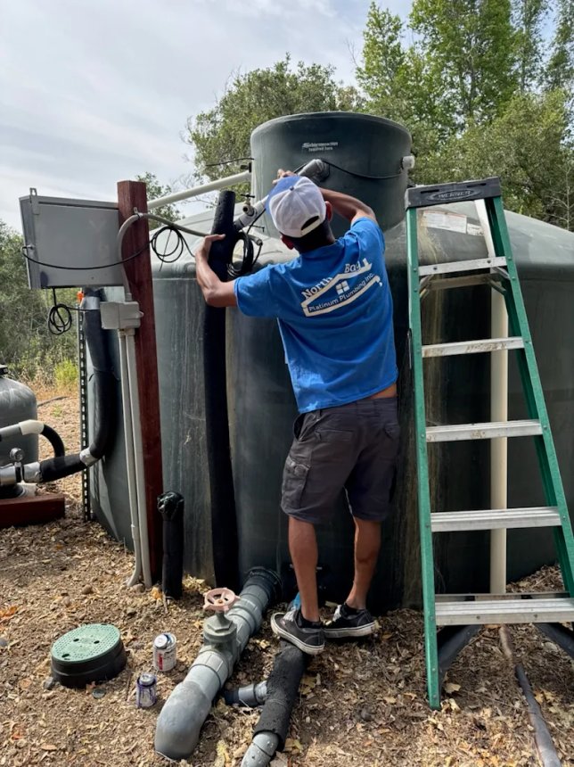 Photo of a plumber detecting a leak