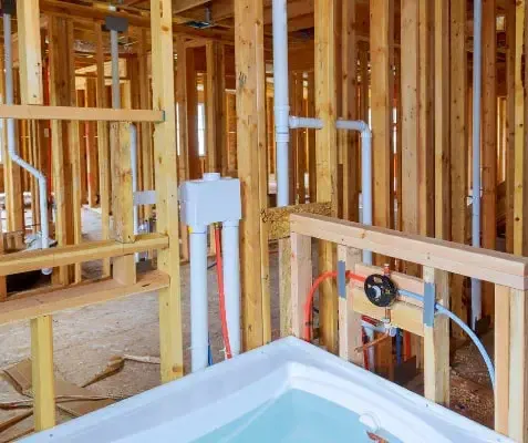 Exposed plumbing during bathroom construction