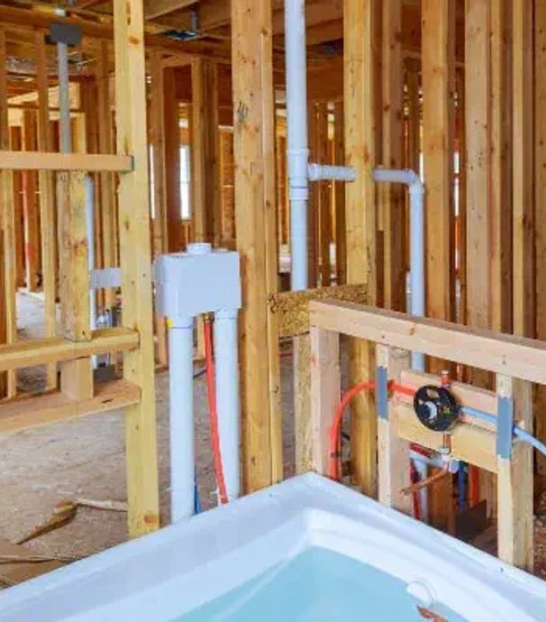 New construction plumbing rough-in with exposed pipes and fittings in Sonoma County