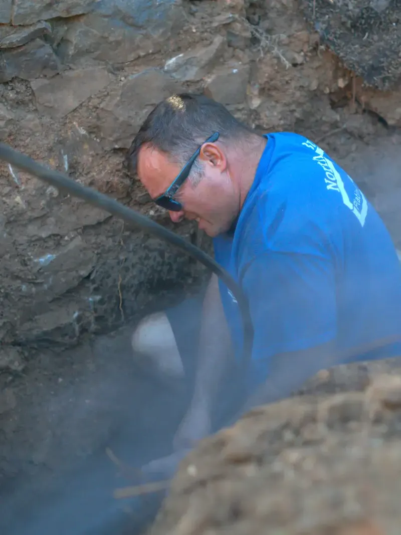 North Bay plumber working in an open pipe trench