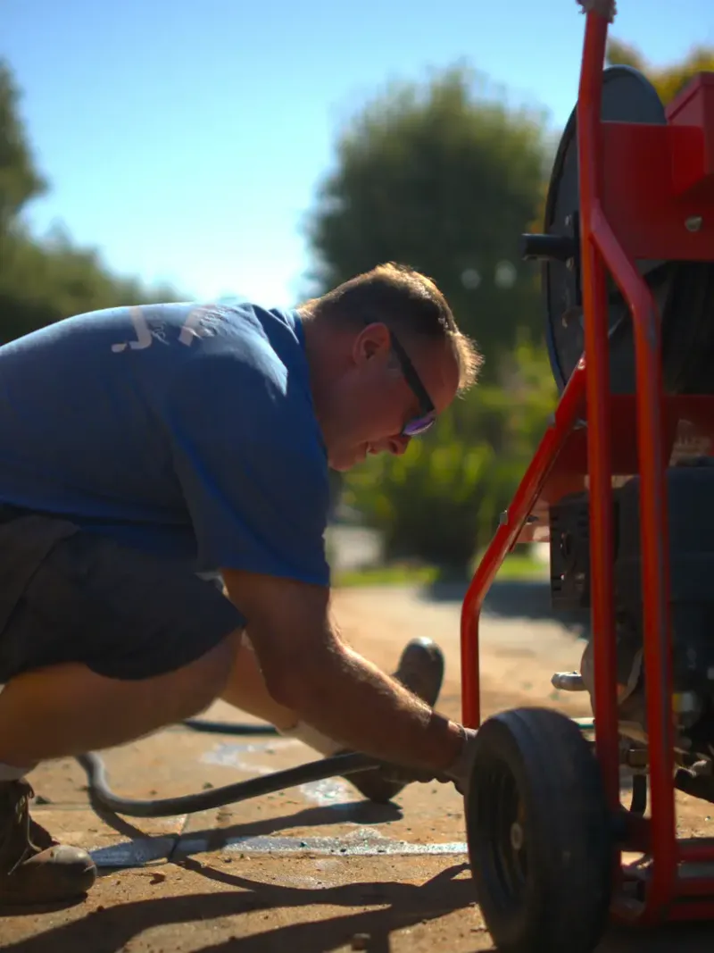 North Bay crew member working with drain service equipment