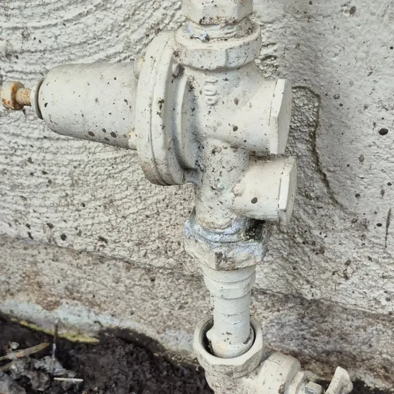 Exterior plumbing valve and pipe connections